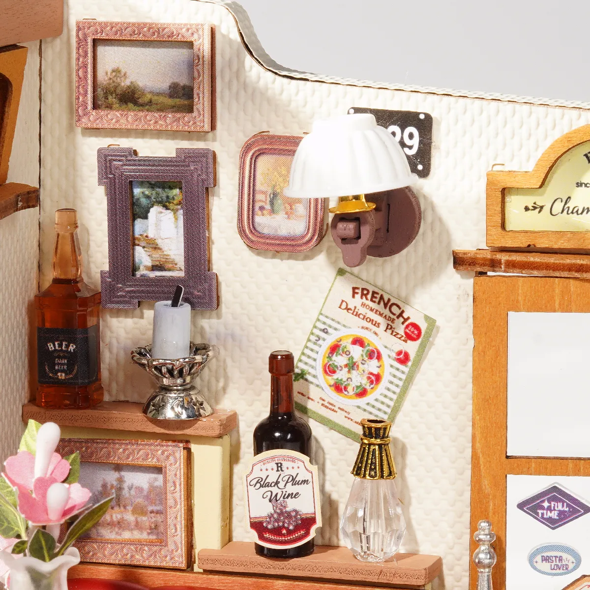 Close-up of Champs-Elysees Bistro wall decor, wine bottle, lamp, and door