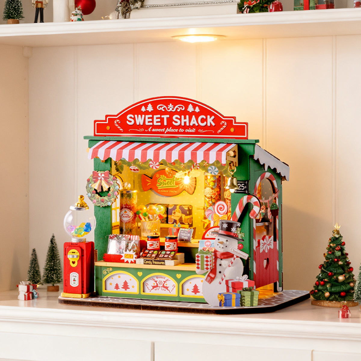 Christmas Candy Stand DS043 tabletop display scene with warm lights on a shelf