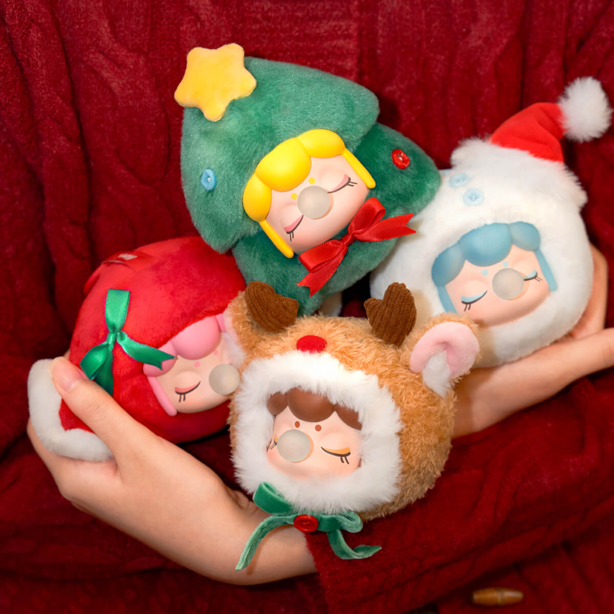 Nanci Christmas Gift collection of three festive plush pendants held in hands