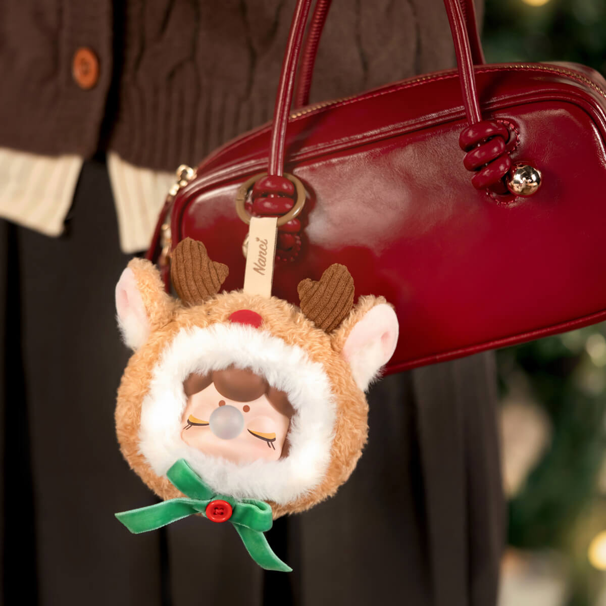 Nanci Christmas Gift reindeer pendant hanging from a handbag