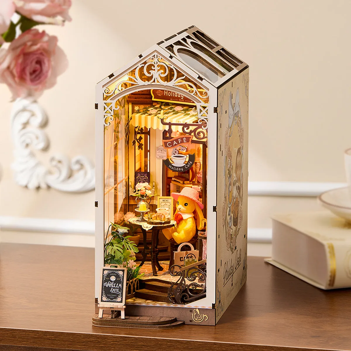 Rolife Holiday Cafe TGB15 book nook in a warm tabletop display beside books