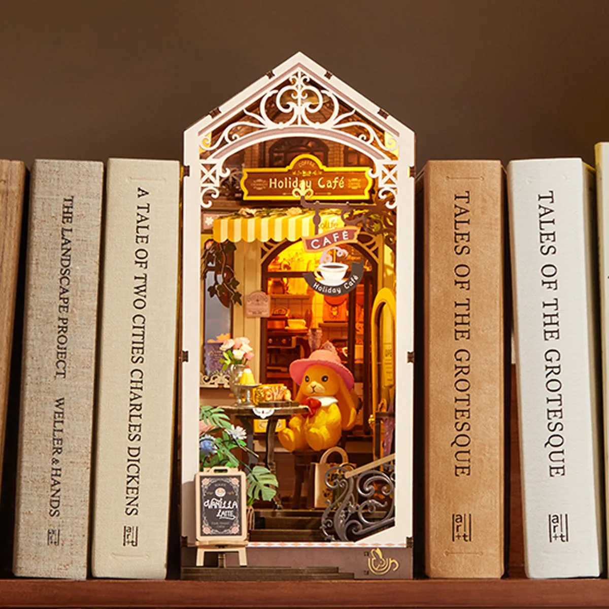 Holiday Cafe TGB15 shelf display between books with warm interior lighting