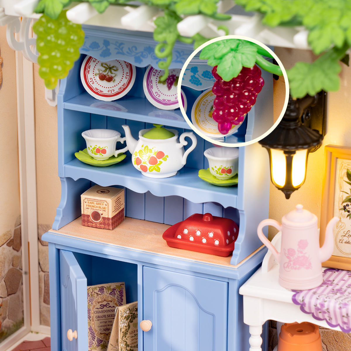 Midsummer Dream Yard DW025 close-up of the blue shelf, tableware, and grape details