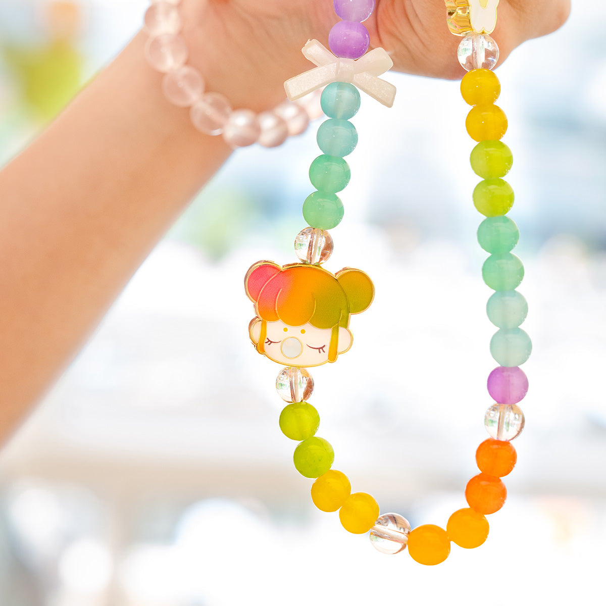 Nanci Sweet Time colorful beaded phone lanyard held in hand