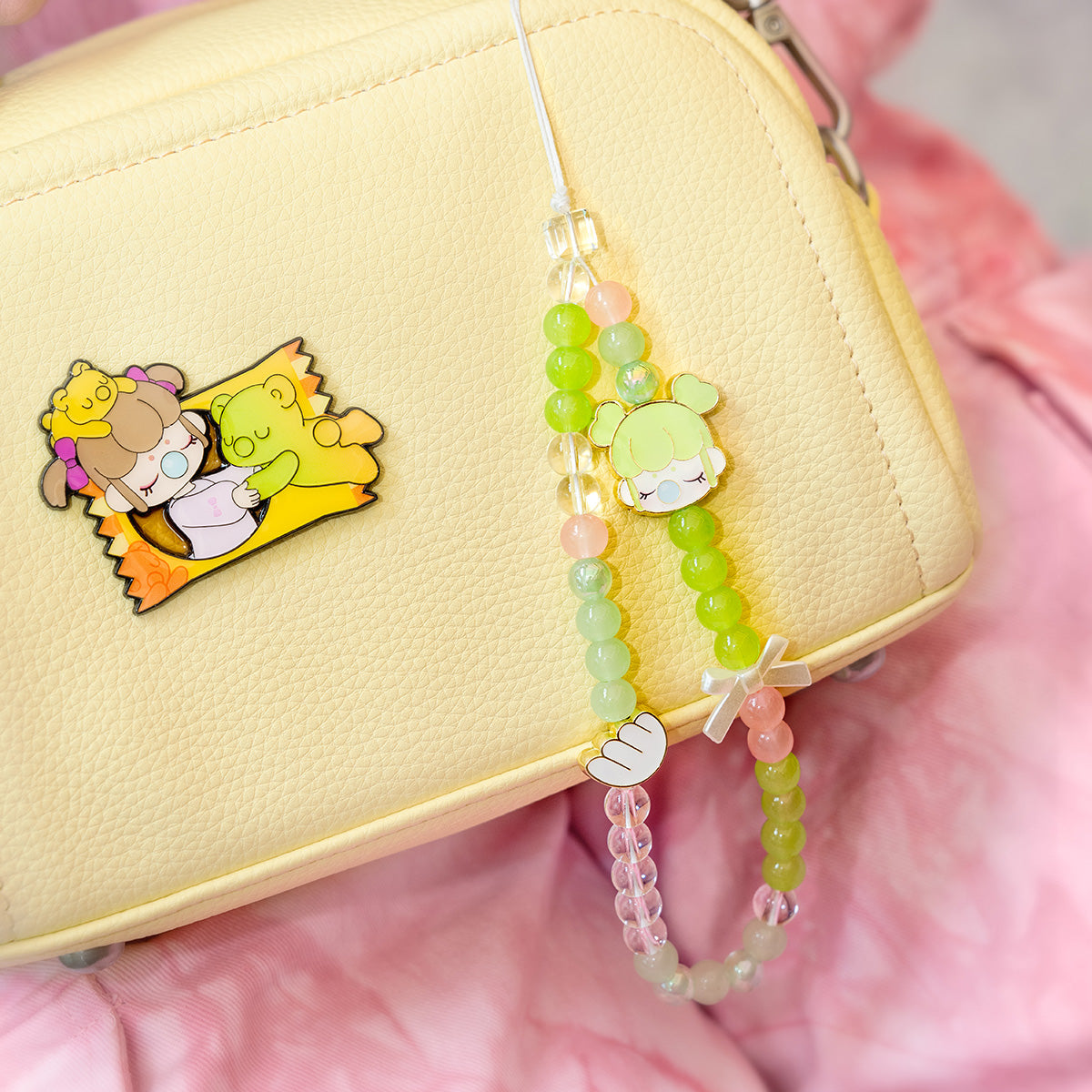 Nanci Sweet Time phone lanyard hanging from a yellow handbag