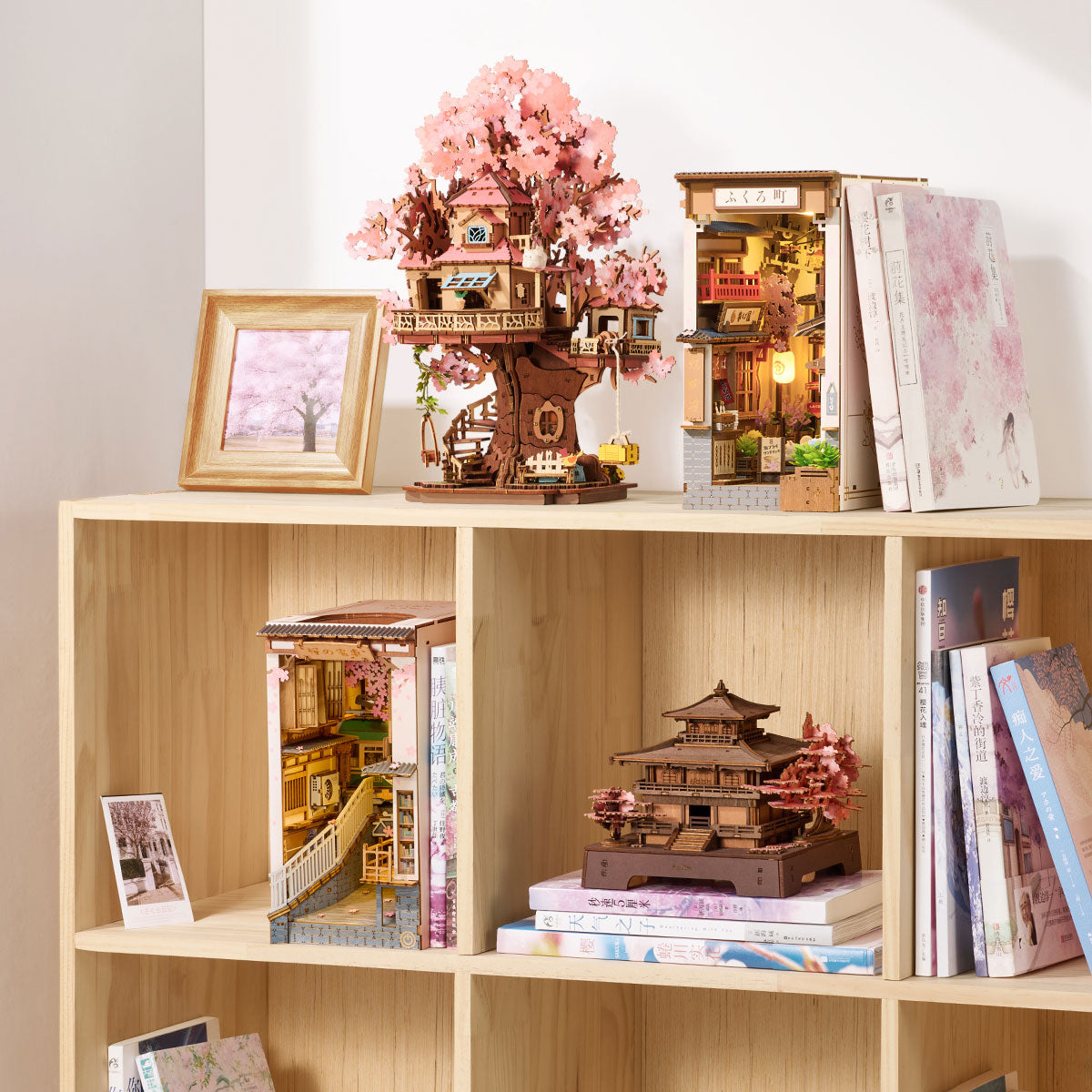 Rolife Sakura Pavilion displayed on a bookshelf with books and other miniature house models