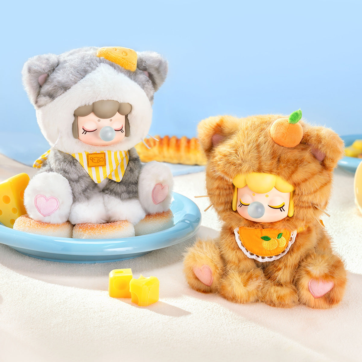 Nanci Tea Time Kitties Sweet Cheese and Orange Bread plush dolls in a blue scene