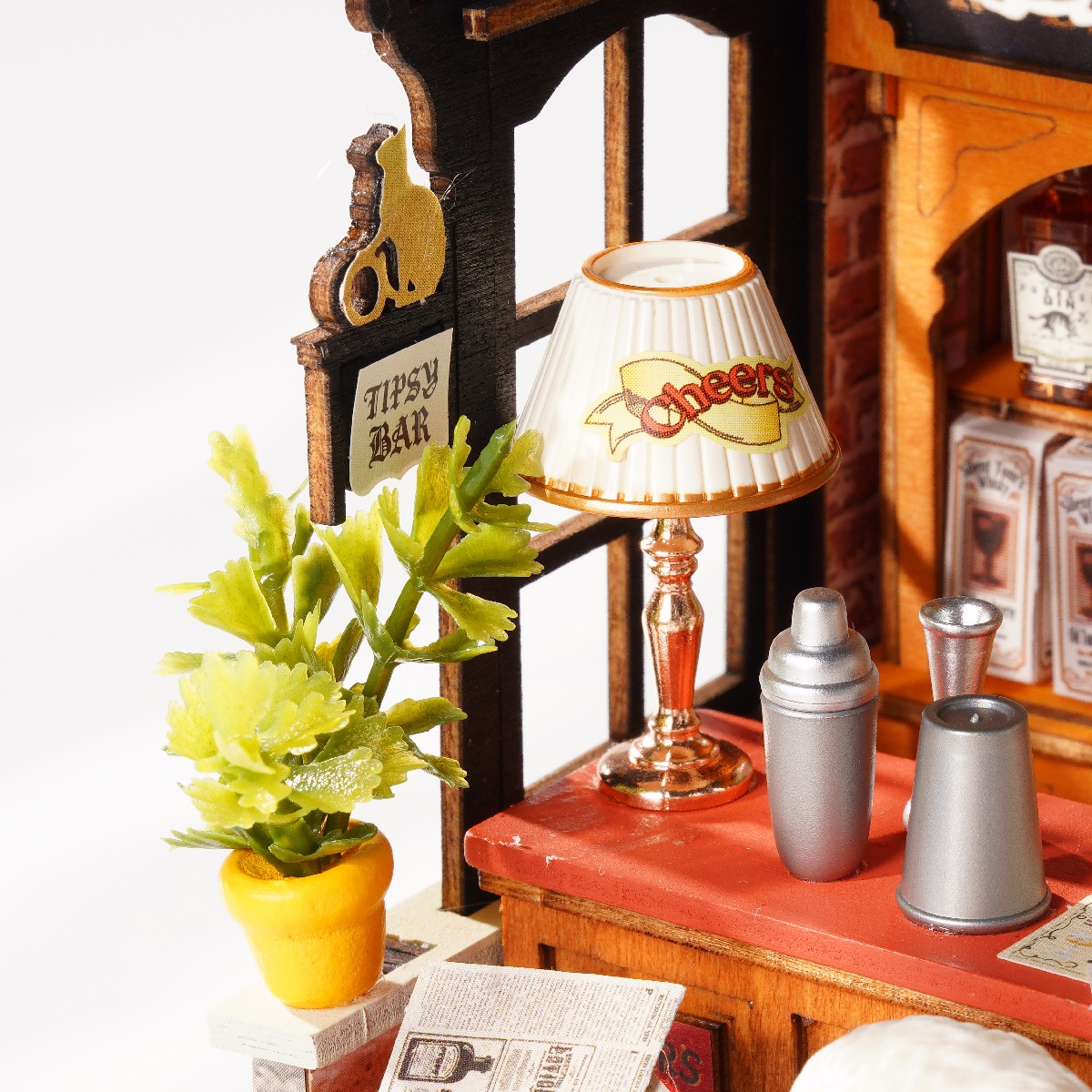 Tipsy Cat Bar side detail with potted plant, table lamp, and drink accessories