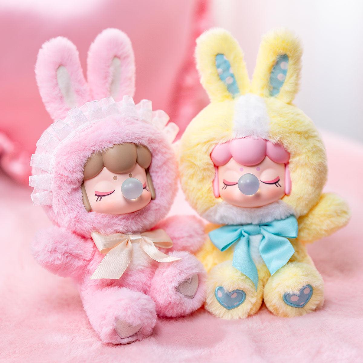 Nanci's Shining Bunny MNBXX pink and yellow plush dolls seated side by side