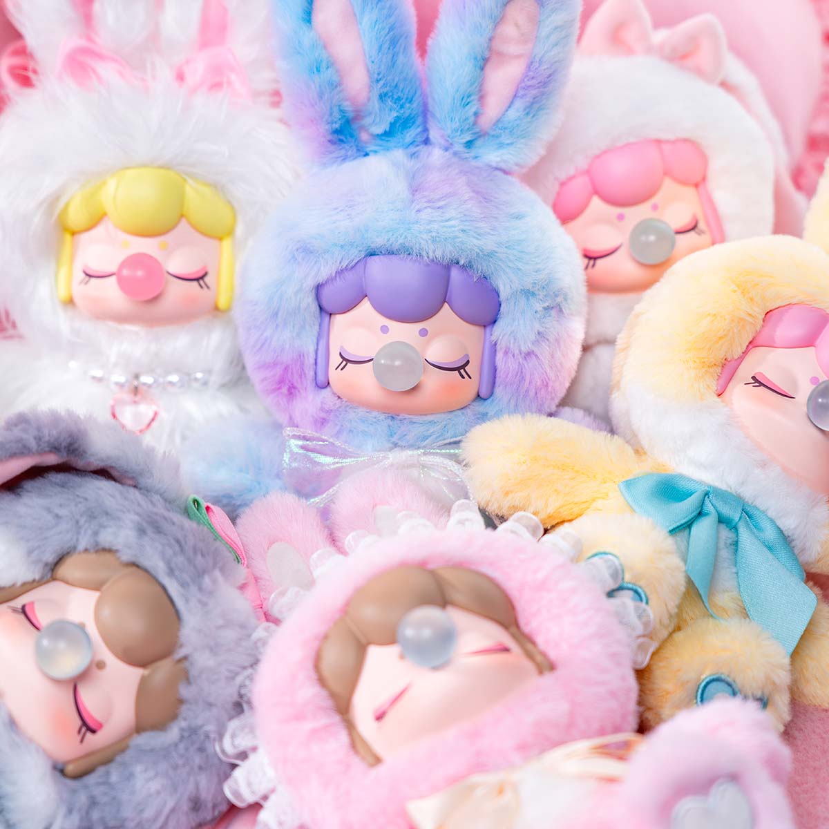 Close-up of Nanci's Shining Bunny MNBXX plush doll lineup in pastel bunny costumes