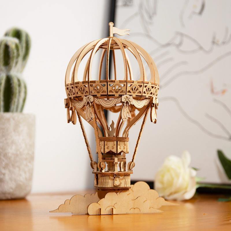Rolife Hot Air Balloon TG406 wooden puzzle displayed beside home decor on a table