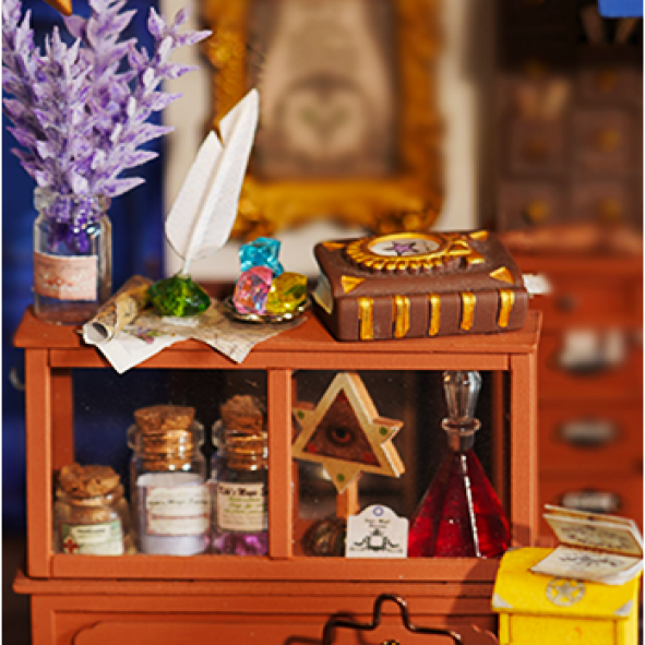 Close-up of Kiki's Magic Emporium counter with books, a feather pen, and bottles