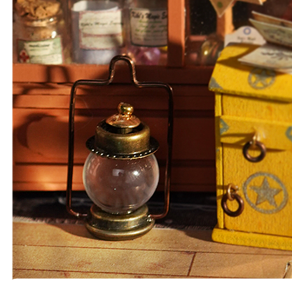 Close-up of Kiki's Magic Emporium lantern and potion bottle on the shop floor