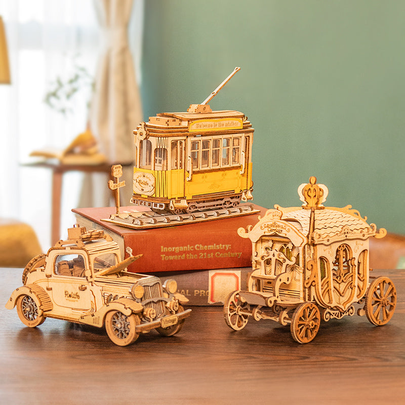 Rolife Vintage Car displayed with other miniature vehicle models and books